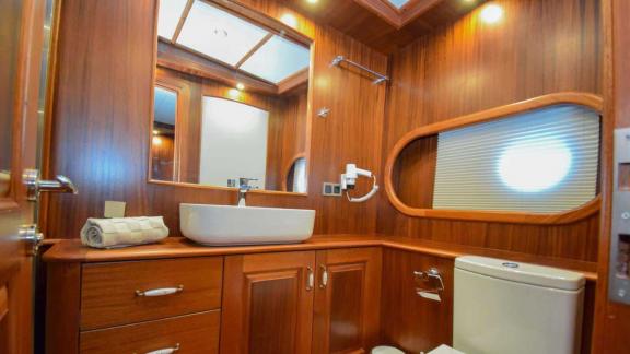 Modern bathroom with stylish wood paneling and luxurious amenities on the Gulet Baba Can.