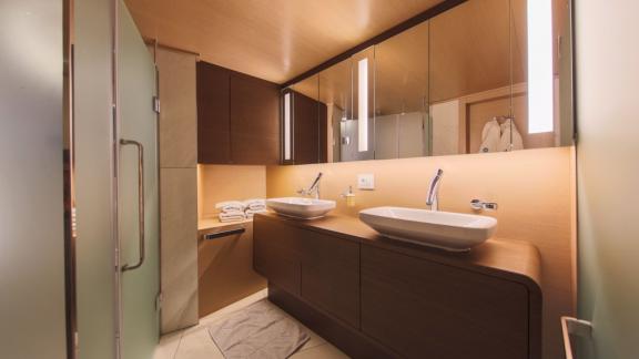 Stylish bathroom on Omnia with two sinks and modern fixtures.