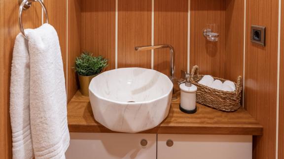 Elegant bathroom of the Gulet Gozdem The One with wooden panelling, modern ceramic washbasin and stylish details.