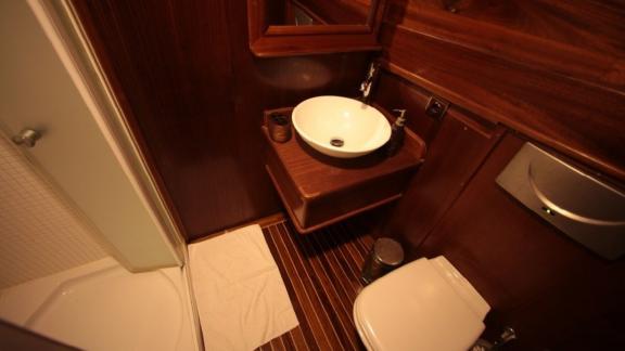 Modern bathroom of the Gulet Doris with glass shower and stylish sink.