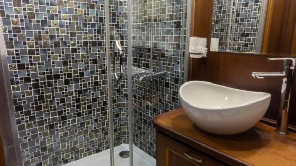 Modern shower of the Gulet Smyrna with stylish tiles and elegant furnishings.