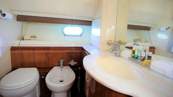 Modern and spacious bathroom on the yacht Kentavros 2, featuring a large mirror and window for a bright atmosphere.