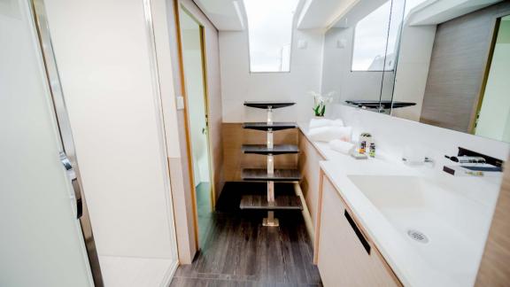 Stylish bathroom with large vanity and access via a compact staircase