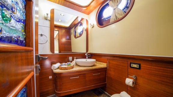 A stylish bathroom on the Gulet La Bella with a large mirror and luxurious fittings.