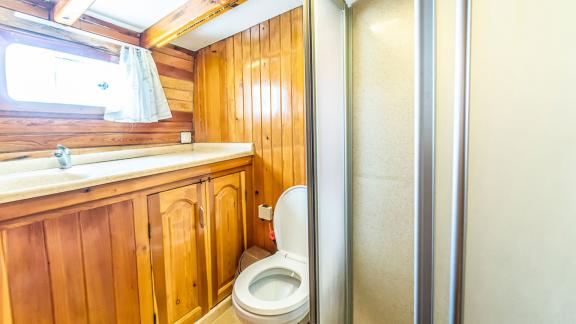 Clean and modern bathroom with wooden paneling. Perfect for comfort at sea.