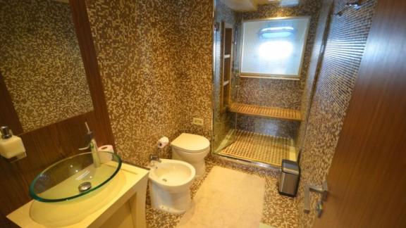 Stylish bathroom with shower and elegant amenities on a motor yacht.