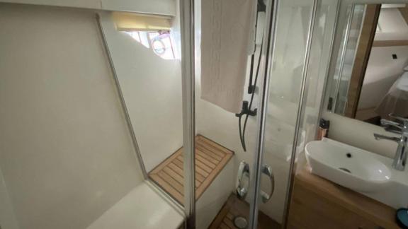 Modern bathroom of motor yacht Serpil D features a spacious shower area and stylish sink.