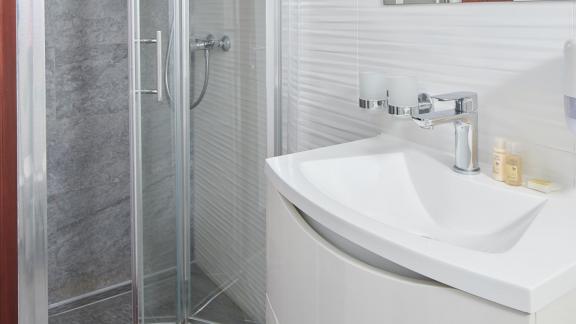 Clean and well-equipped bathroom with shower on the yacht.