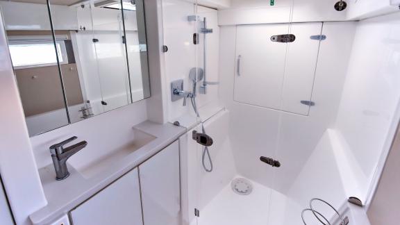 The modern bathroom on catamaran Derya features a spacious shower area and practical design for comfort.