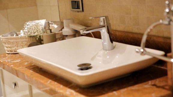 Modern sink on the sailing yacht with an elegant marble surface and decor.