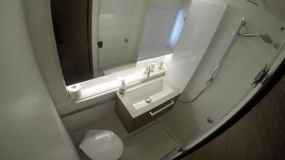 The modern bathroom on the Lagoon 50 features an elegant shower, sink, and stylish fixtures for comfort.