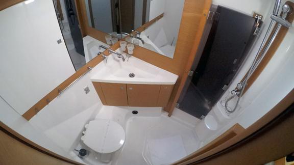 The bathroom on Whyknot yacht features a modern shower, sink, and toilet.