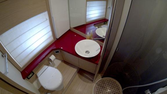 The modern bathroom on motor yacht Sabijac features a sink, toilet, and shower cabin.