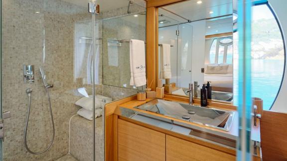 The Yacht For Ever features an elegant bathroom design adorned with wooden details.