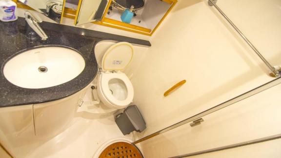 Bathroom of motor yacht İmera equipped with modern shower cabin and sink.