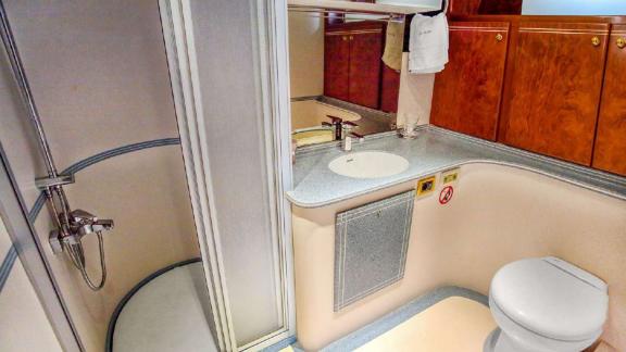 Modern bathroom on motor yacht Julem 1 with shower, sink, and toilet.