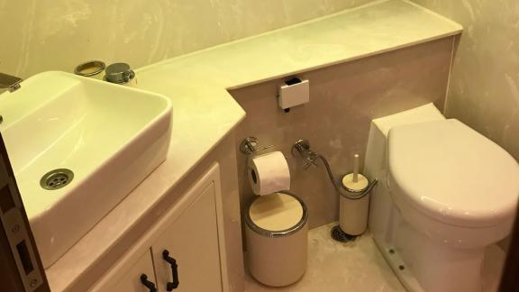 A sleek bathroom with a white sink and toilet, designed to be simple and functional for maximum comfort.