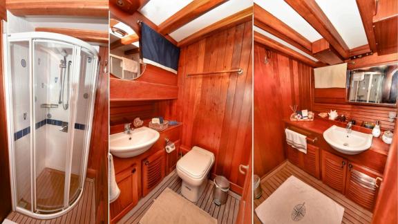 The bathroom of gulet Barka features wooden details, a spacious sink area, and a shower cabin with elegant design.