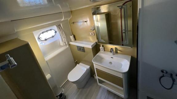 The bathroom on Angelo 2 yacht features a modern sink and a stylish shower.