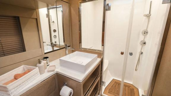 The guest bathroom on yacht La Luna features a modern design with a stylish sink and spacious shower.