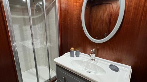 The bathroom of gulet Rose Sah is equipped with a shower cabin and a stylish sink area.