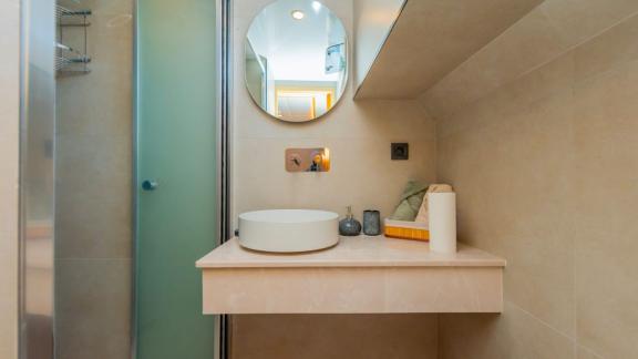 The bathroom of trawler yacht Kaan Bey 2 stands out with a modern shower cabin and minimalist design.