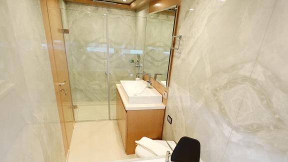 The bathroom on Princess Melda yacht offers a modern atmosphere with a glass shower cabin and stylish sink.