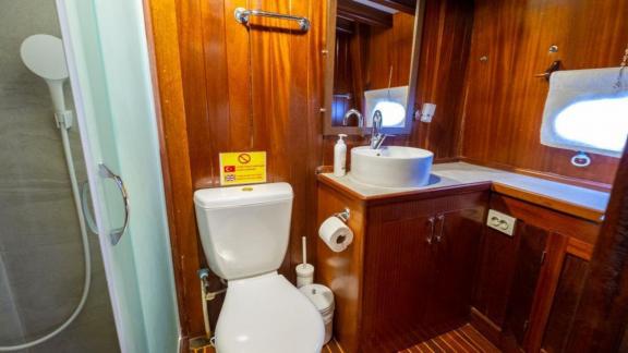 Bathroom of Gulet Cemre Junior with a shower and sink.