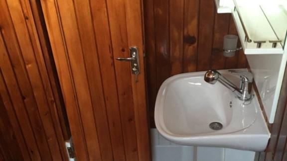 Small and stylish bathroom on Gulet Aurora surrounded by wooden details.