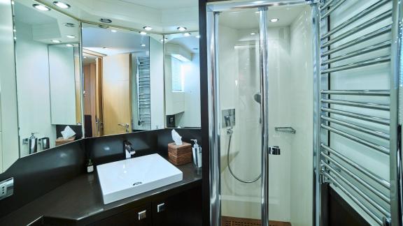 Stylish bathroom with large mirrors and a spacious shower on the motor yacht Lady KC.