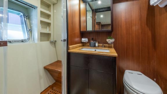 The bathroom on the motor yacht Aya One features wooden accents and modern fixtures, offering a comfortable space.