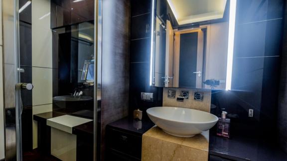 The modern bathroom on motor yacht Chilli offers luxury with stylish lighting and contemporary decor.