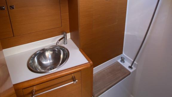 The bathroom of the Yerdeniz sailing yacht features a modern sink and a comfortable shower area.