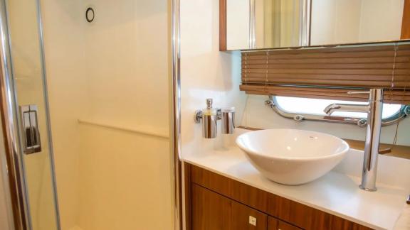 Modern bathroom with sink and shower on the Midnight Summer Dream yacht.