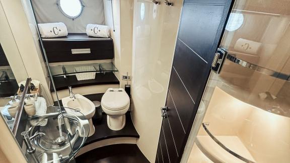 The bathroom on motor yacht Esperanza combines style and functionality with a modern design, shower area, and a small wi