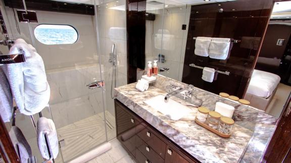 The elegant guest bathroom of the Legende motor yacht adds luxury and comfort to your Dubai yacht rental experience.