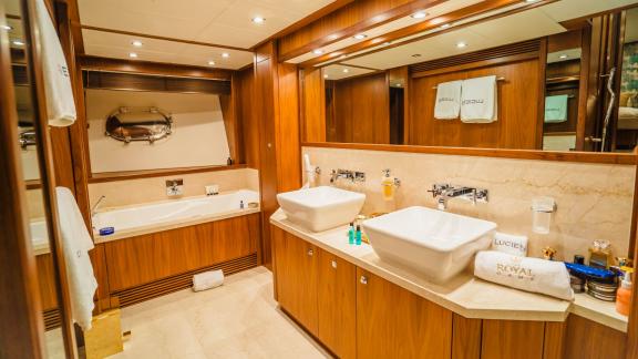 The spacious and stylish bathroom of the Lucien motor yacht enhances your luxury yacht charter in Dubai.