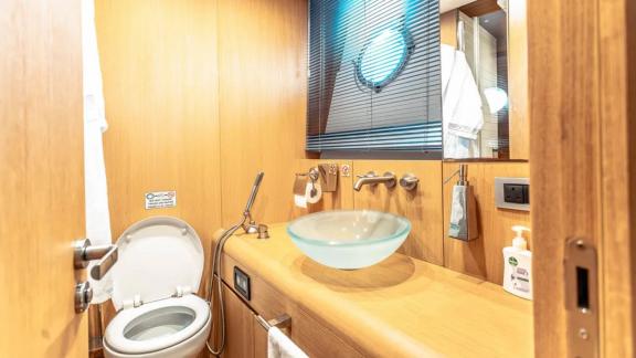 The modern bathroom on Tayget yacht completes the luxury Dubai yacht rental experience.