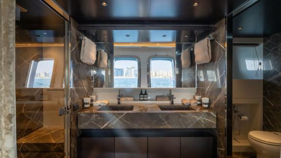 The luxurious bathroom of San Lorenzo Sx88 blends elegance and functionality for your Dubai luxury yacht rental.