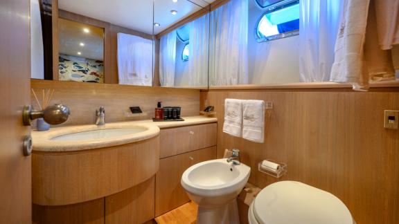 Experience comfort in the stylish bathroom of Sandi IV with an Italy motor yacht rental.