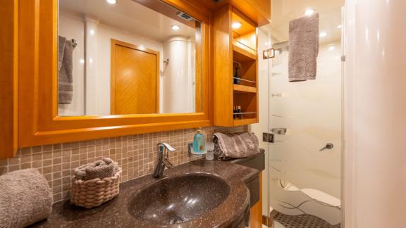 Experience comfort in Lady B’s modern bathroom with weekly yacht charter in Italy.