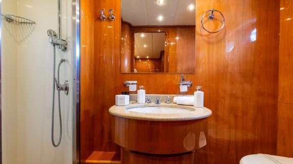 The elegant bathroom of the Shangra motor yacht enhances the luxury yacht charter experience in Olbia, Italy.