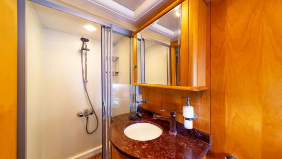 Luxurious bathroom with wooden details on Mein Schatz gulet. Perfect for weekly luxury yacht charter in Turkey.