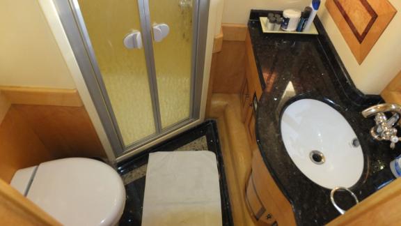 The bathroom on motor yacht Ser 1 features a modern shower and stylish countertop.