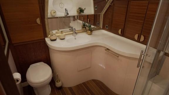 This Göcek motor yacht features a refined bathroom space with luxury accents.