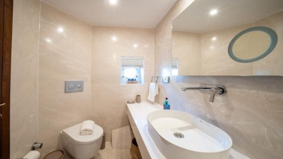 Elegant sink and windowed toilet area featured on Fethiye-based yacht charter.