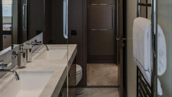 The bathroom of Lady M in Mallorca includes double sinks, mirror and towel rack.