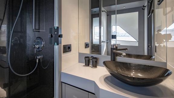 Designer sink and modern glass shower on a motor yacht cruising near Mallorca.