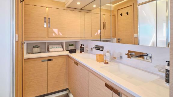 The bathroom of the Sunmoon yacht offers a spacious feel with a large mirror and modern design.