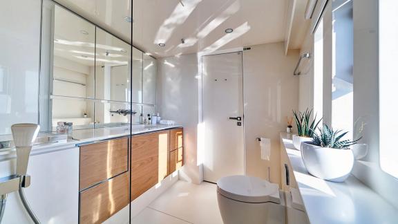 Sunreef 60 Sinata offers a sleek guest bathroom filled with natural light and elegant finishes.